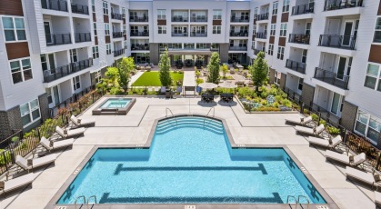 Resort-style swimming pool with lounge seating