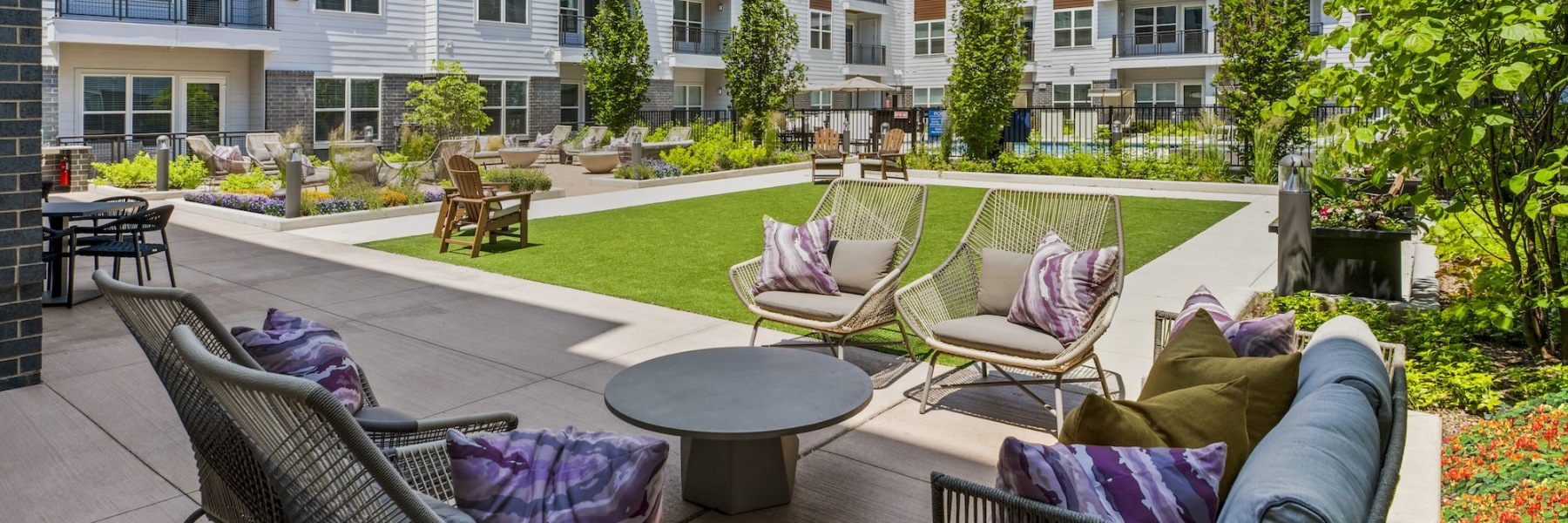 a spacious flowering courtyard with lounge area