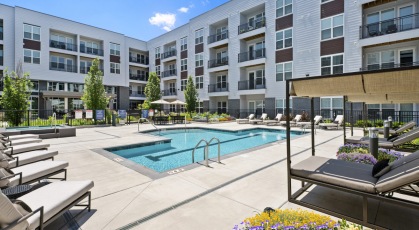 Resort-style swimming pool with lounge seating
