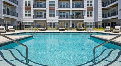 Resort-style swimming pool with lounge seating