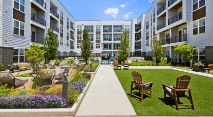 a flowering lawn with Adirondack chairs