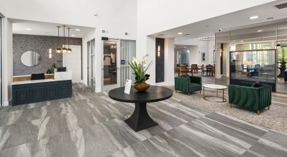 a spacious lobby with green chairs