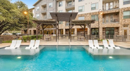 Resort-style swimming pool with lounge seating
