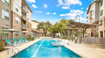 Resort-style swimming pool with lounge seating