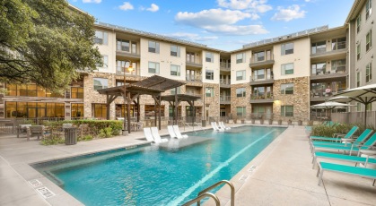 Resort-style swimming pool with lounge seating