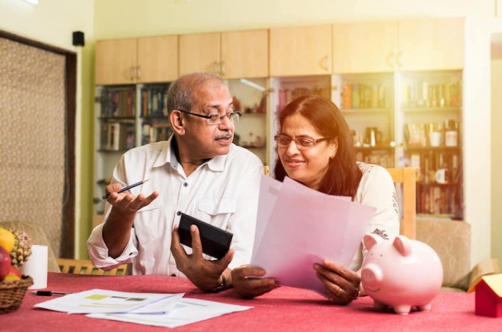 couple calculating cost of staying at home 