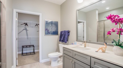 Large well lit bathroom with white accents 