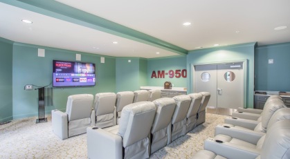 Large well lit movie theatre with leather seating