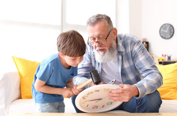 grandpa and grandson fixing a clock