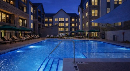 Resort-style swimming pool with lounge seating