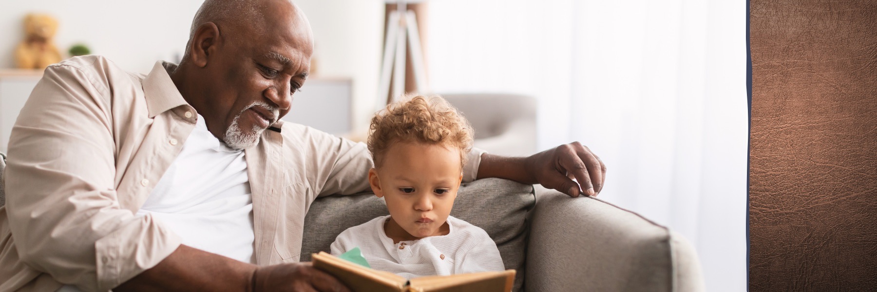 a grandfather and his grandson reading a book