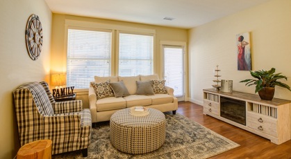 spacious living room brightly lit with access to private balcony