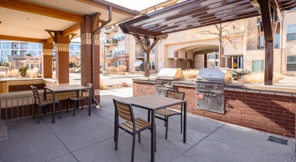 outdoor grill area with tables and chairs