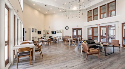 large, open recreational room with tables and chairs