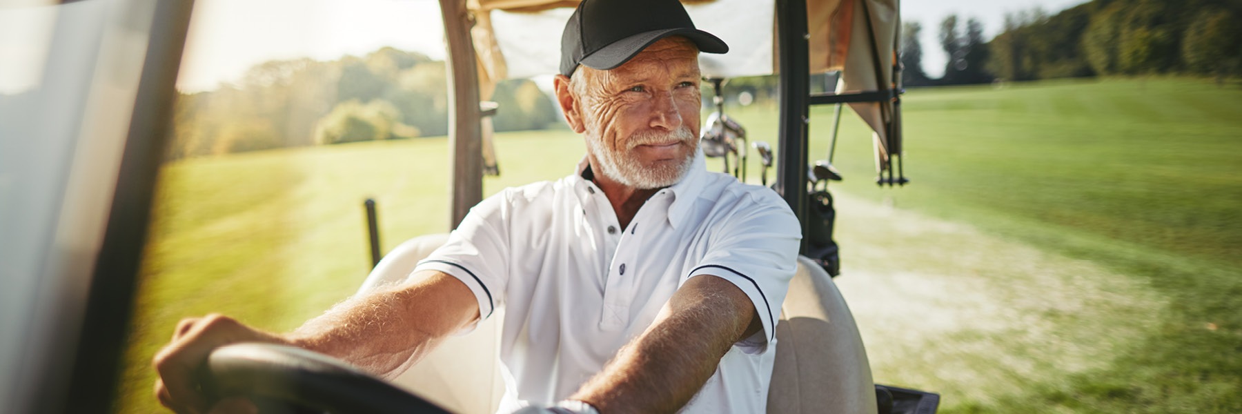 man driving a golf court on a course