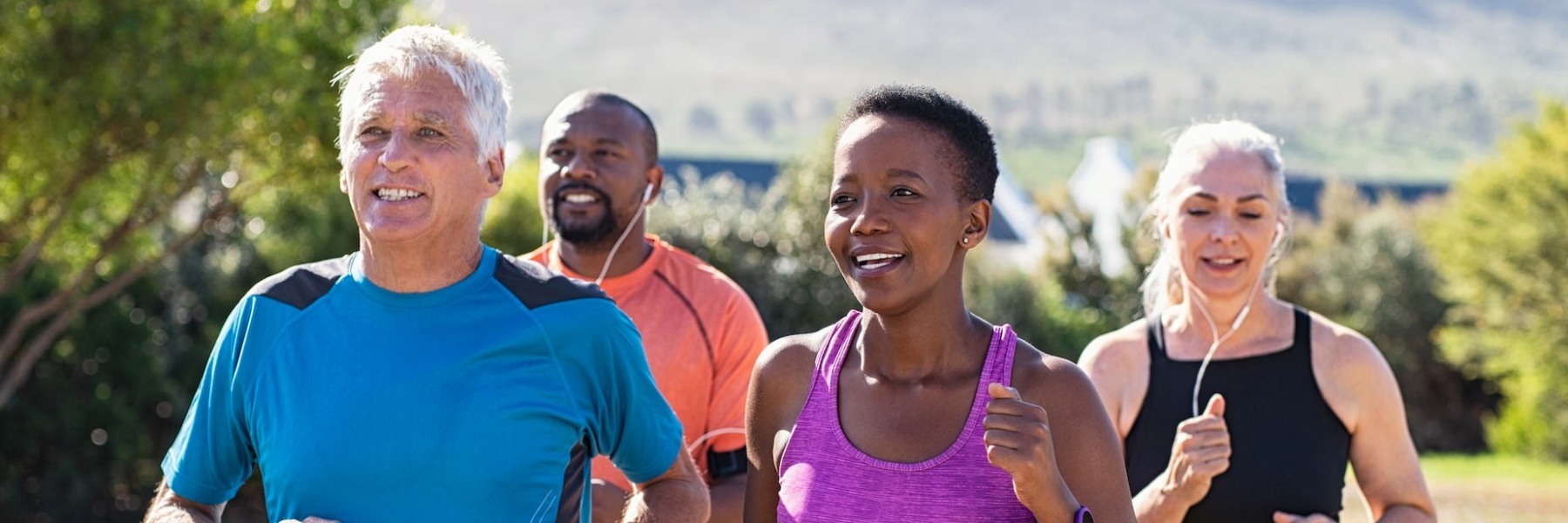 Residents running outside near Everleigh San Clemente Apartments in Orange County, featuring trees in the background.